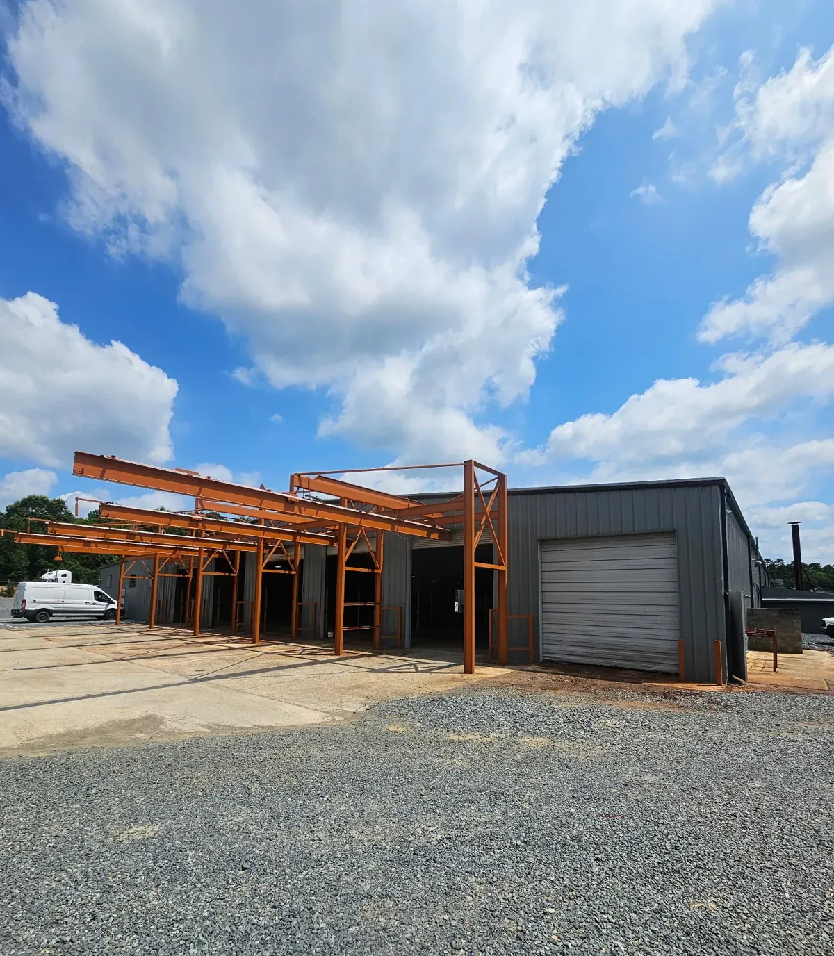 Warehouse exterior with roll-up door and steel canopy